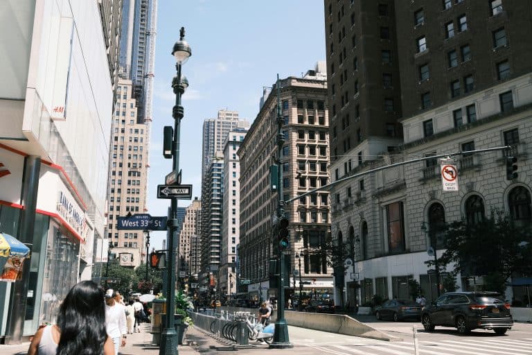 A vibrant view of West 33rd Street in New York City showcasing urban life and architecture.