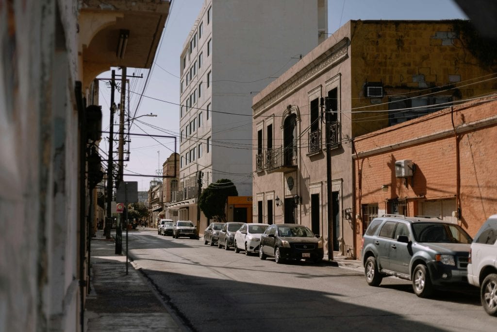 Charming architectural street view in Heroica Matamoros, Mexico, showcasing colonial buildings and urban life.