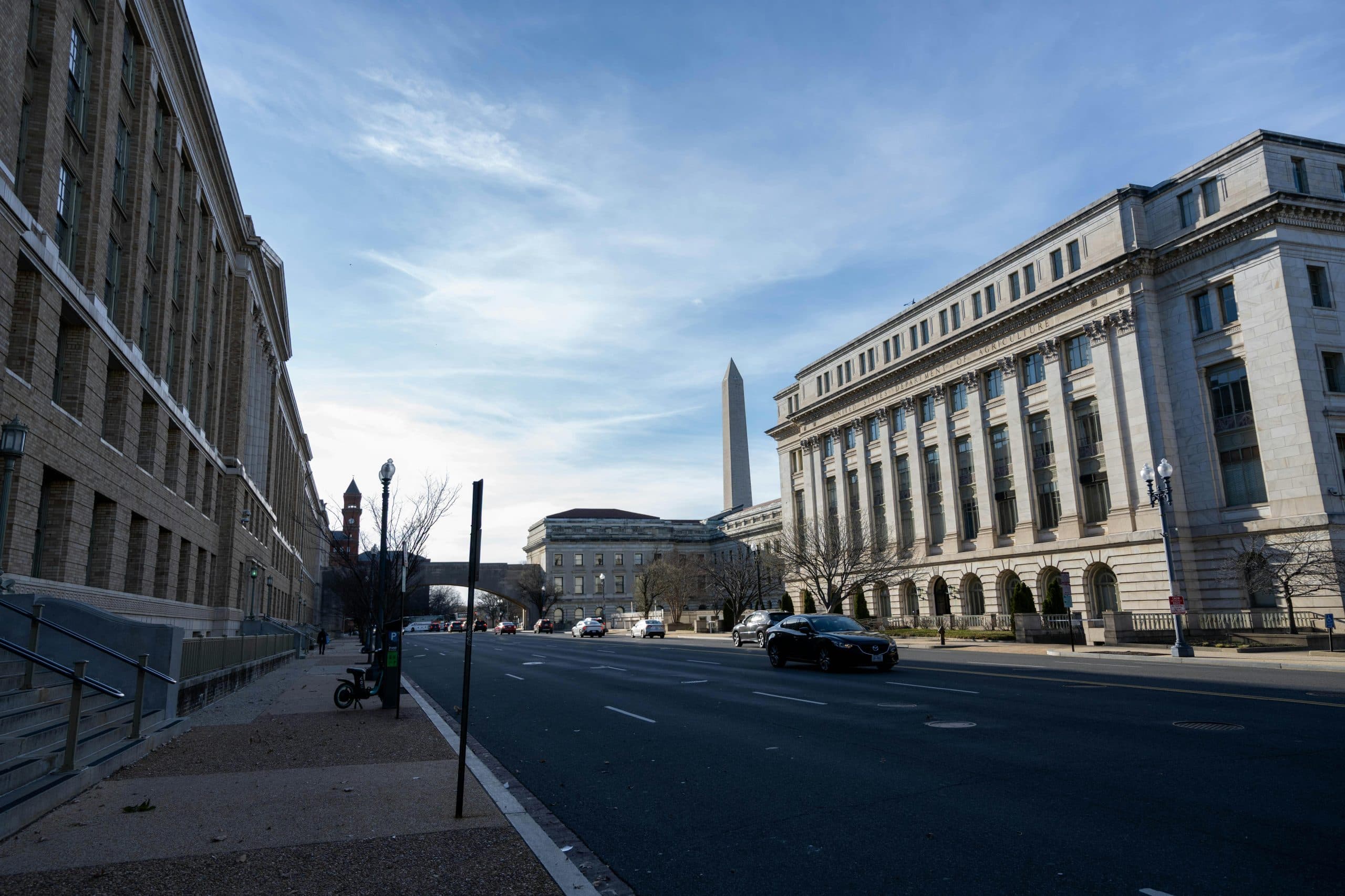 Street view in Washington DC featuring historic buildings and the Washington Monument.