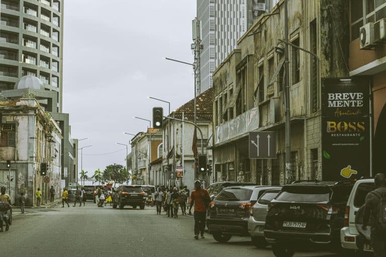 Bustling street scene in downtown Luanda, Angola with historic and modern buildings.