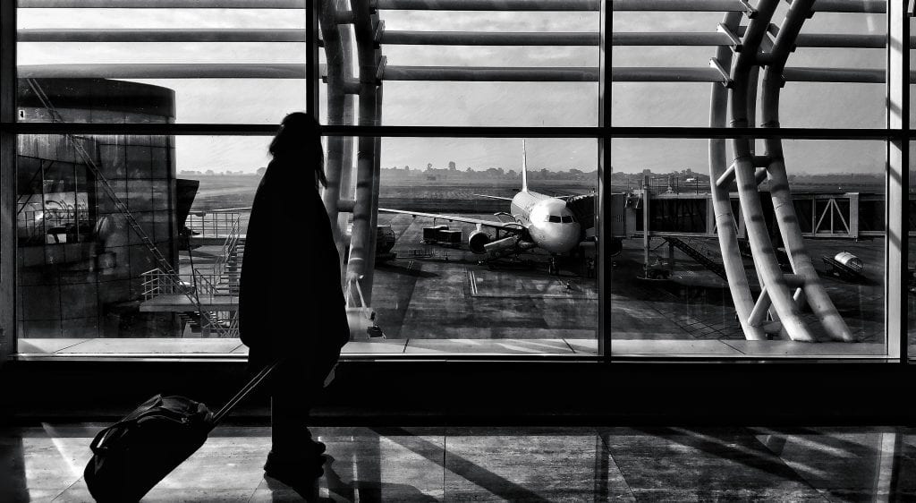 Silhouette of a traveler walking in Naya Raipur airport terminal, India.