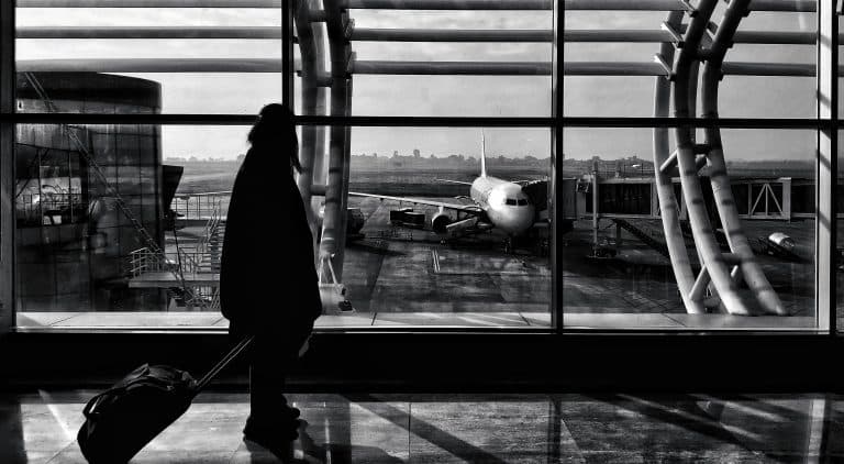 Silhouette of a traveler walking in Naya Raipur airport terminal, India.