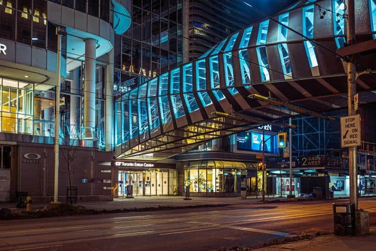 New York Blogs | Articles | News | Tips & Tricks | Video | FAQ | Information | Infograph. 45 Nighttime view of the Toronto Eaton Centre and surrounding area, highlighting urban architecture and illuminated walkways.