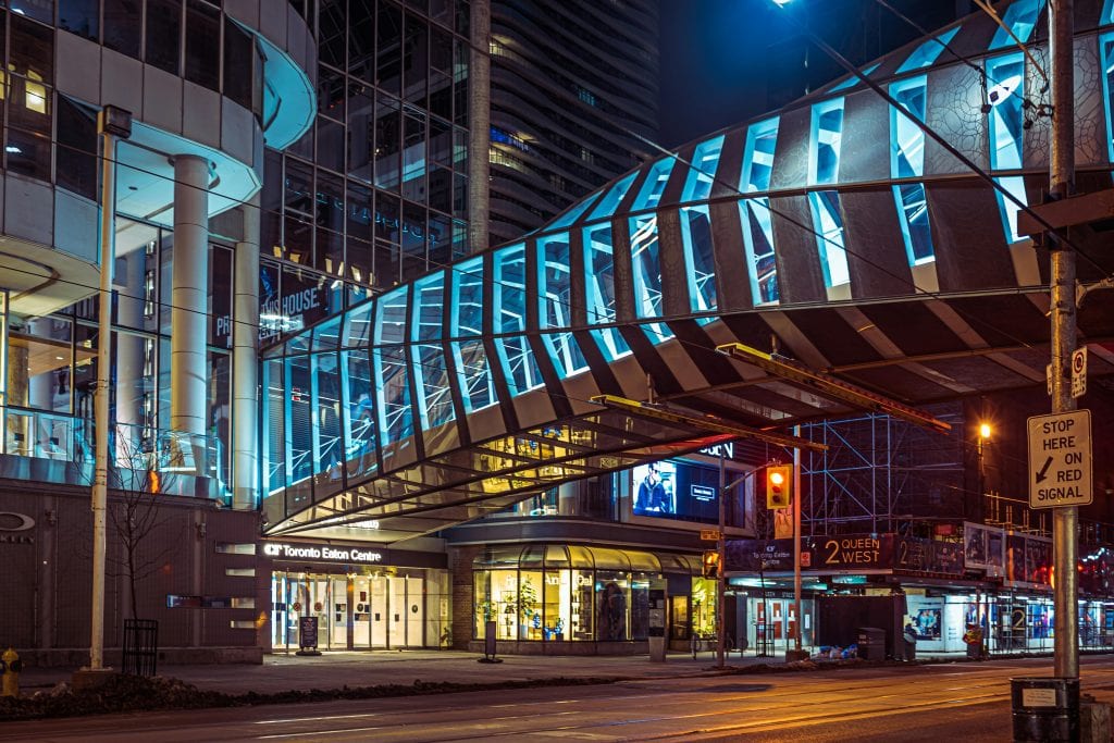 Night view of Toronto Eaton Centre showcasing modern architecture and city lights.