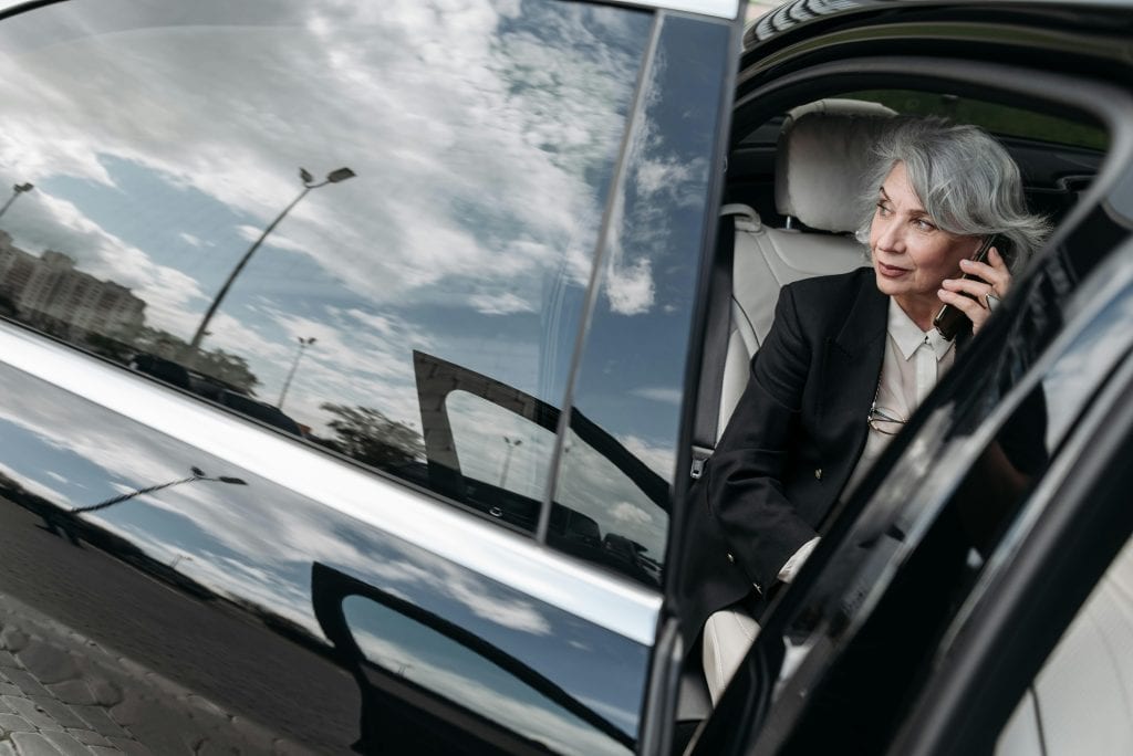 eco friendly car service NYC to JFK hybrid SUV at JFK airport arrivals terminal