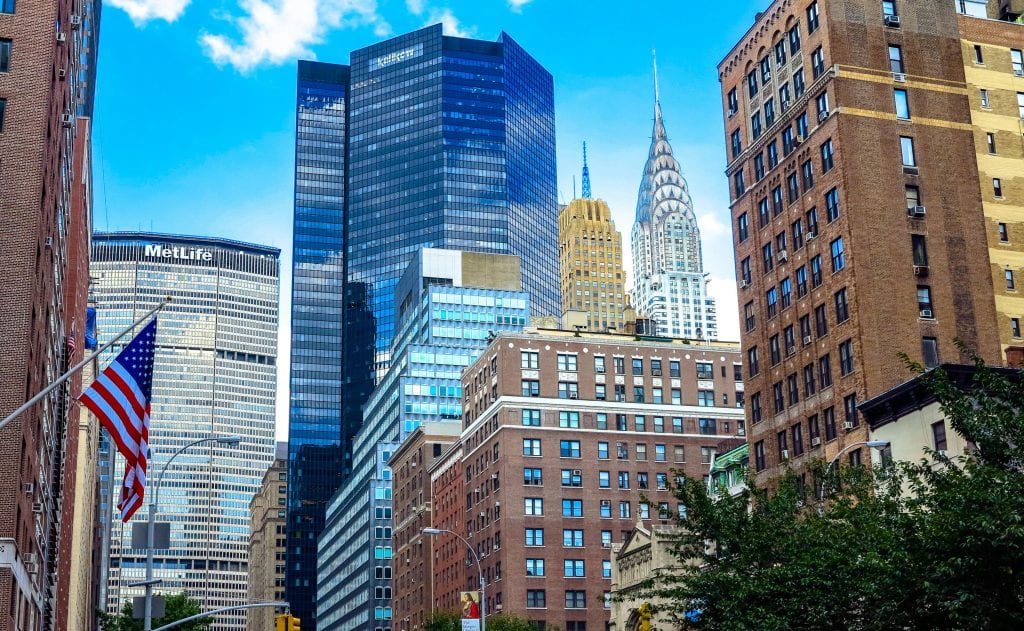 Eco Friendly Town Car Service New York City in 2026: The Ultimate Guide to Sustainable Luxury Rides, Lower Emissions, and Stress-Free Airport Transfers 11 Stunning view of Midtown Manhattan skyscrapers including the Chrysler Building under a blue sky.