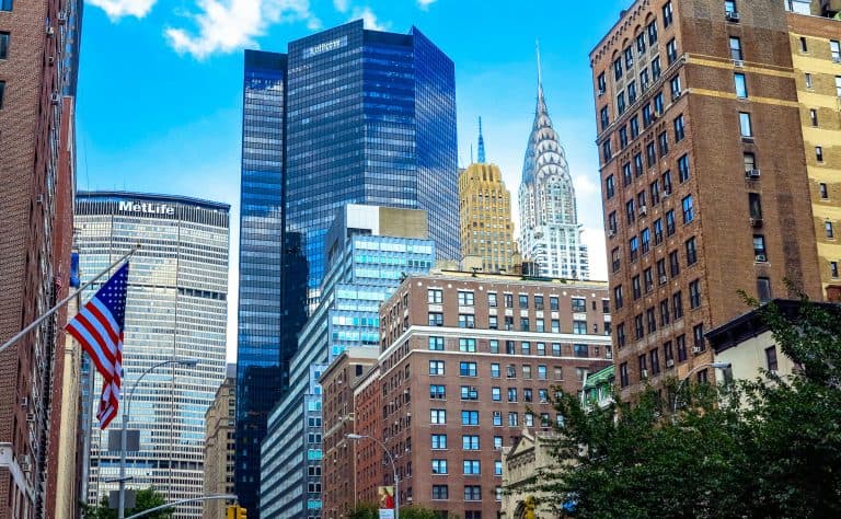 Stunning view of Midtown Manhattan skyscrapers including the Chrysler Building under a blue sky.