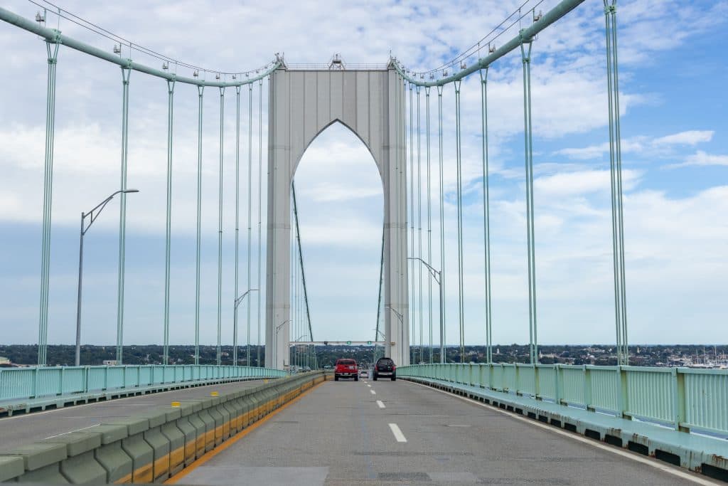 How Much Is a Car Service to Newark From Staten Island: 5 Honest Cost Factors in 2026 7 Suspension bridge in Newport, RI with vehicles on a sunny day.