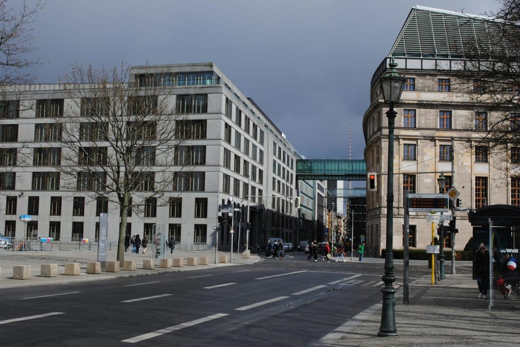 Car Service Near JFK Reviews 2026: Your Ultimate Guide to Reliable Airport Transfers in a Changing City 5 A dynamic street scene in Berlin, featuring modern architecture and bustling city life under a cloudy sky.