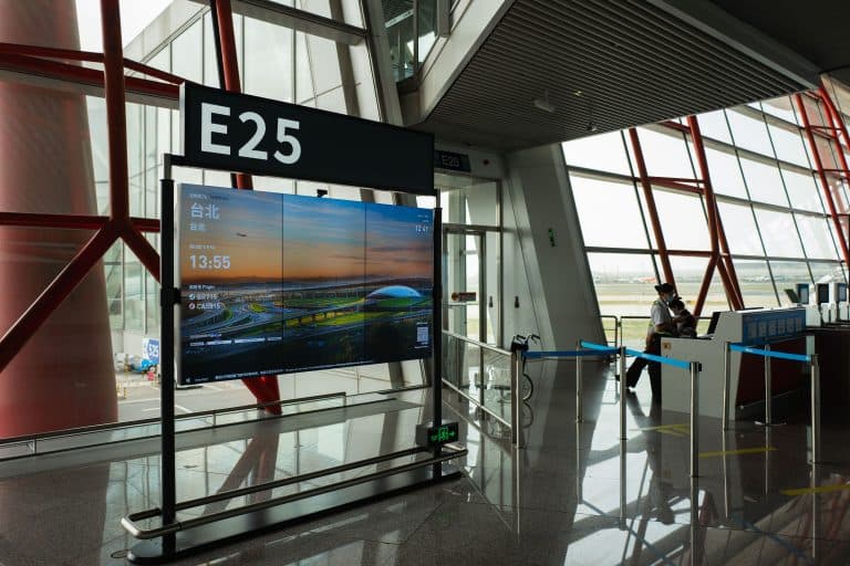 Places & Attractions Blogs | Articles | News | Tips & Tricks | Video | FAQ | Information | Infograph. 31 A view of a modern airport terminal showcasing Gate E25 with a flight display board.