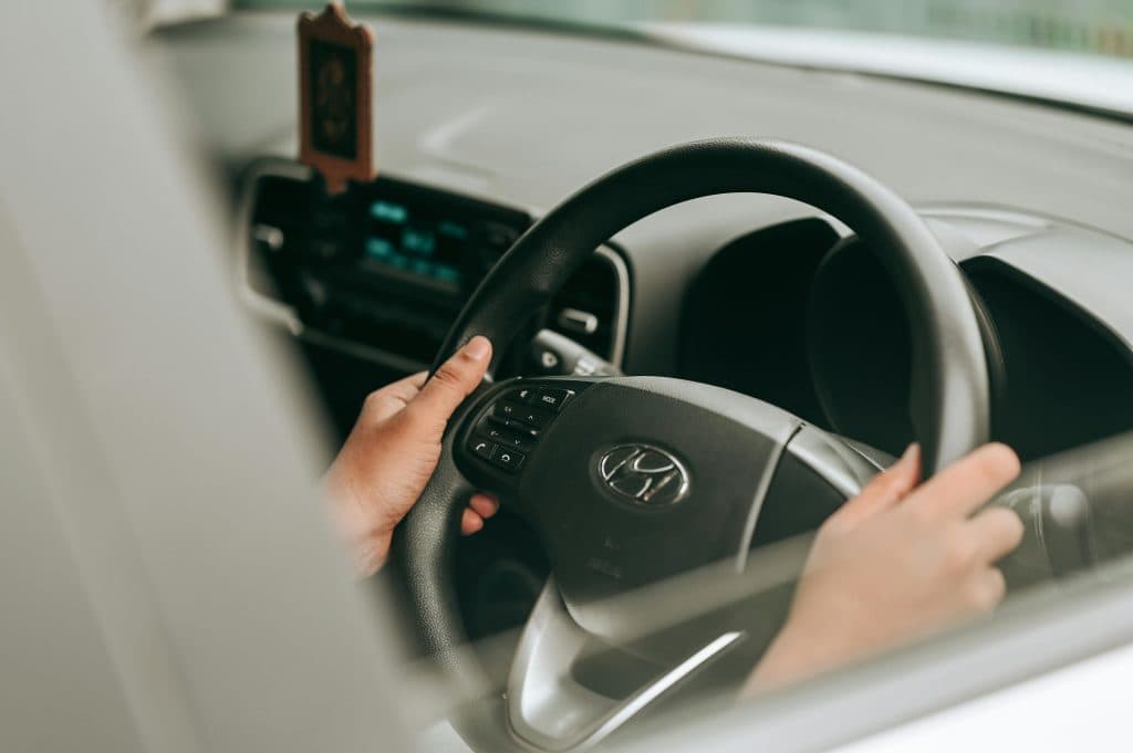 Car Service from Newark to Brooklyn Reviews 2026: Your No-Surprise Guide to Reliable Airport Transfers 5 Close-up view of hands holding the steering wheel inside a car.