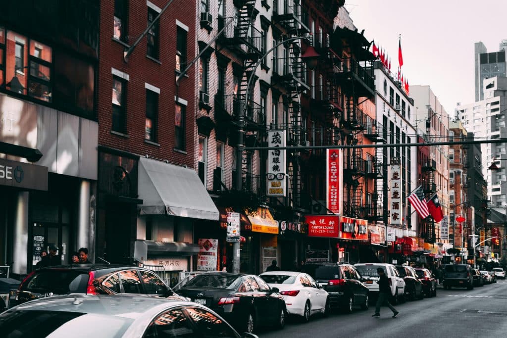 Reliable New York City Town Car Service: 6 Honest Facts for 2026 15 Busy urban street scene featuring traffic and city buildings in daylight, capturing vibrant urban life.