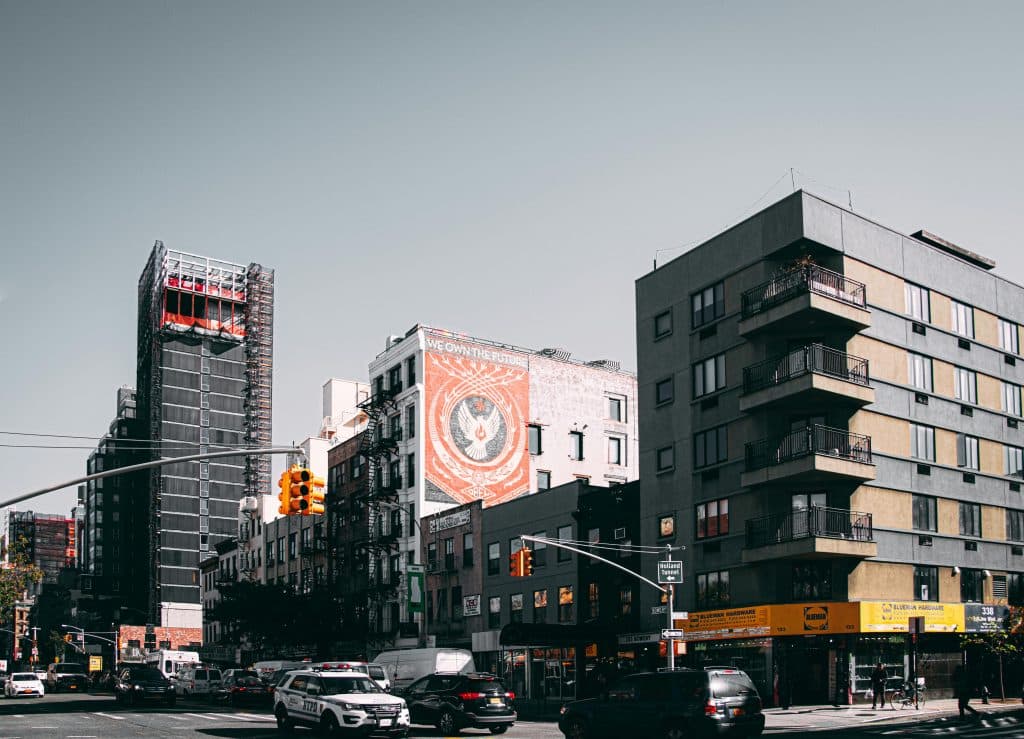 Affordable New York City Town Car Service in 2026: Your Smart Escape from Surge Pricing Chaos and Airport Headaches 17 Cityscape of a busy urban intersection with modern buildings and street traffic during the day.