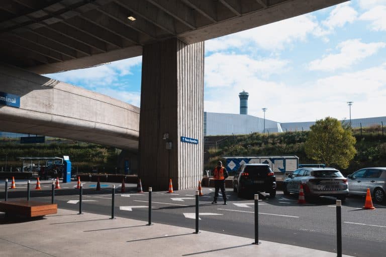 Airport Transfer Blogs | Articles | News | Tips & Tricks | Video | FAQ | Information | Infograph. 13 A bustling airport entrance with vehicles and people in Roissy, France.