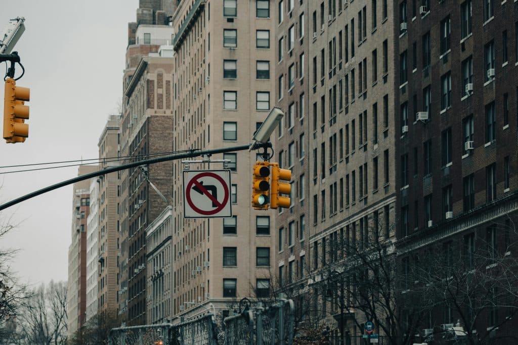 Winter cityscape featuring tall buildings, traffic lights, and urban architecture captured on a street corner.