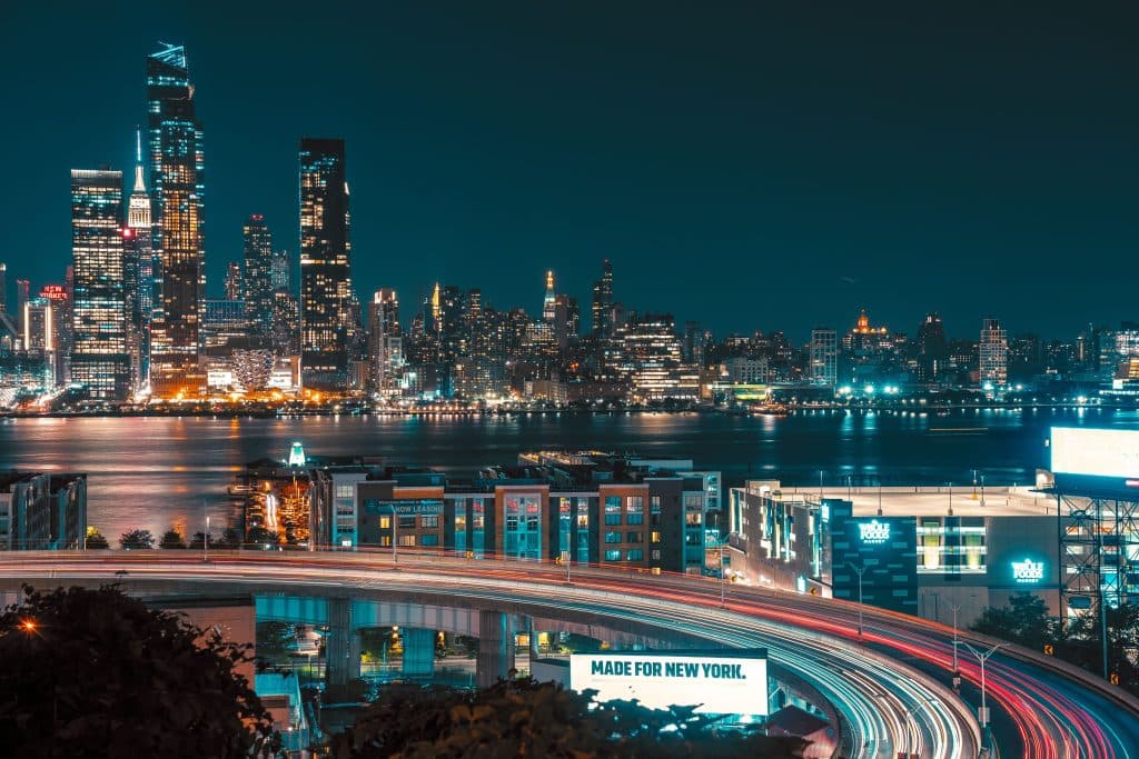 Eco Friendly New York City Town Car Service in 2026: The Smart Choice for Sustainable Luxury Transfers 19 A stunning night view of New York City's skyline with illuminated skyscrapers and a bustling highway.