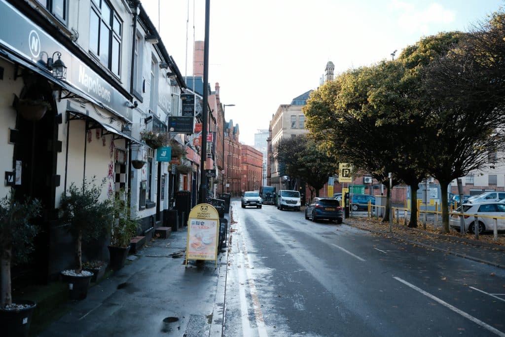 A picturesque urban street view showcasing historic architecture and autumn foliage.