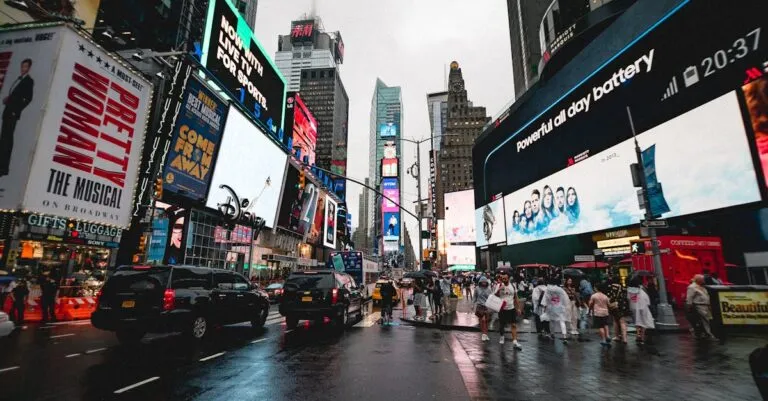 Night view of Times Square in NYC with illuminated billboards and a lively crowd.
