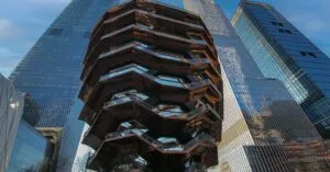 Dramatic view of the Vessel and surrounding skyscrapers in New York City's Hudson Yards.