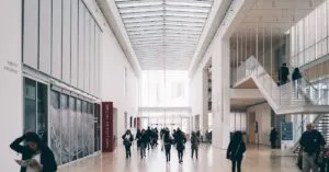 Spacious art gallery lobby with visitors in a modern architectural setting.