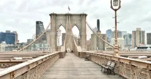 Iconic Brooklyn Bridge view with Manhattan skyline in the background, featuring classic architecture.