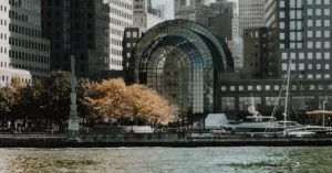 Elegant cityscape featuring modern waterfront buildings and a marina in an urban setting.