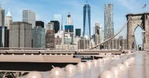 A stunning view of the Brooklyn Bridge with the Manhattan skyline under a clear blue sky.
