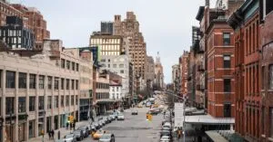 Busy New York City street showcasing urban architecture and bustling traffic at daytime.
