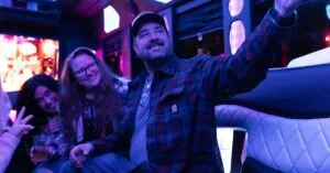 Friends taking a selfie inside a vibrant party bus, creating lasting memories.