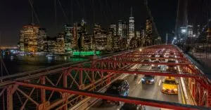 Stunning night view of Manhattan skyline and traffic on Brooklyn Bridge, New York City.