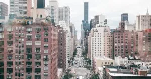 Aerial perspective of a bustling New York City street lined with skyscrapers.