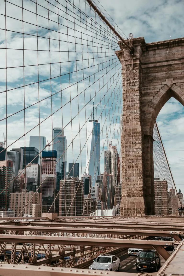 Iconic view of Brooklyn Bridge with Manhattan skyline and One World Trade Center in New York City.