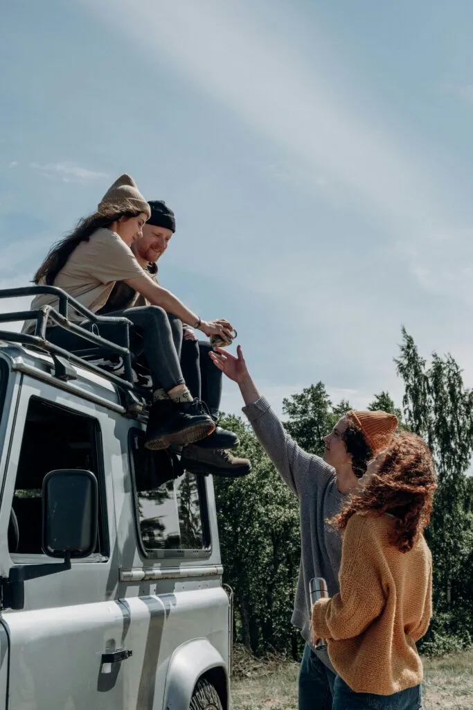 JFK Car Service for Groups: Navigating NYC's 2025 Airport Chaos with Ease 17 Group of friends enjoying a summer road trip with an SUV, relaxing outdoors and having fun.