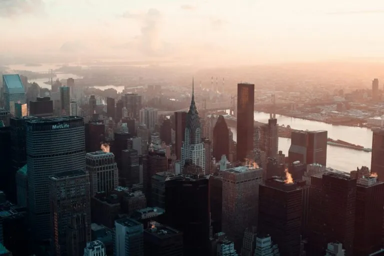 Aerial view of New York City's skyline at dawn featuring the Chrysler Building.