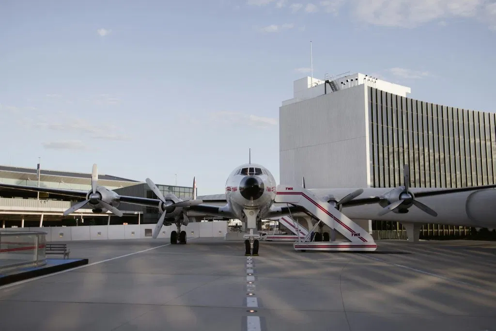 Luxury Limo Service JFK: The Real Deal for Getting Out of Hell in 2026 1 Historic aircraft parked at TWA Hotel showcasing classic aviation design in New York City.